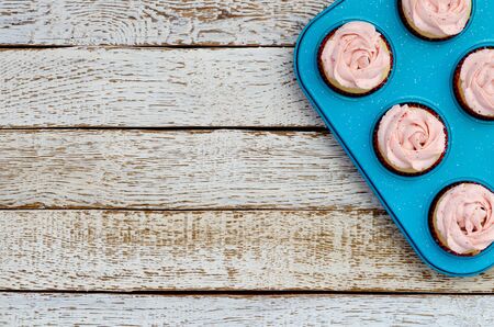 cupcakes on the baking tray on a white wooden tableの写真素材