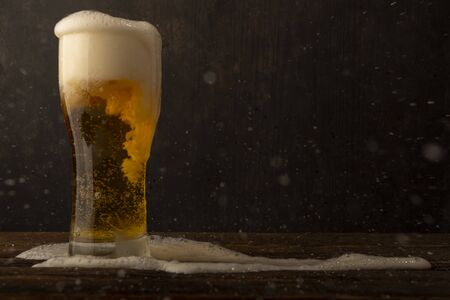 Glass beer on dark background with copyspace