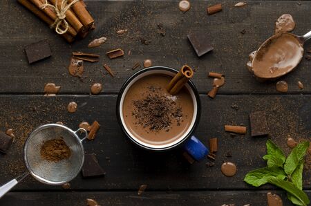 cup of hot chocolate on black wooden boards with drops of chocolateの写真素材