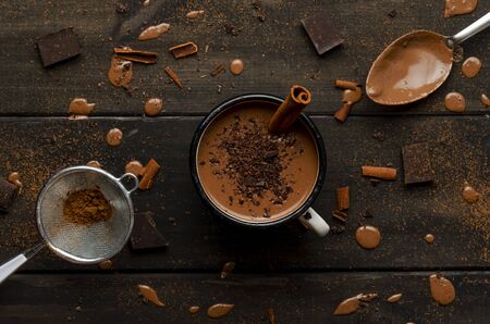 cup of hot chocolate on black wooden boards with drops of chocolateの写真素材