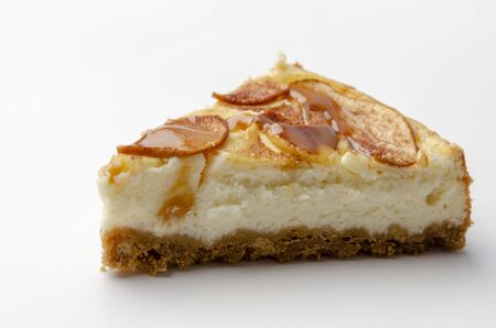 apple Cheesecake with caramel isolated on white