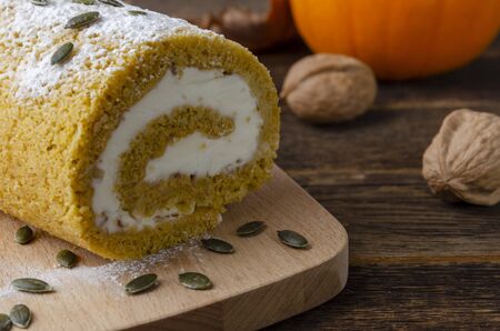 Pumpkin Roll with powdered sugar with walnuts and pumpkinの写真素材