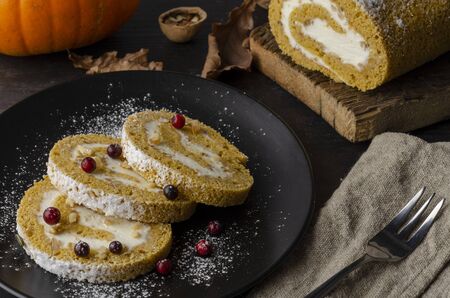 Pumpkin Roll with powdered sugar with walnuts pumpkin seedsの写真素材