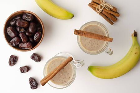 Glasses of date milkshake with cinnamon and spiceの写真素材