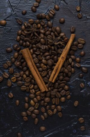 Roasted coffee beans and spice on a darkの写真素材