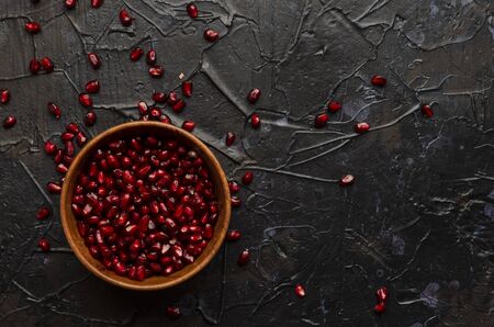 bowl with pomegranate seeds on darkの写真素材