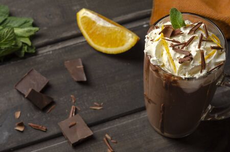 Hot Chocolate with cream in Tall Glass on blackの写真素材