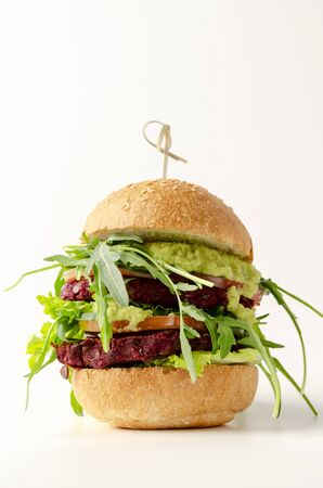 Veggie beet and lentil burgers with vegetables and avocado sauce.の写真素材