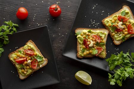 Vegan sandwich with avocado, nuts, vegetables and olive oilの写真素材