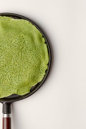 spinach or matcha russian pancakes on the pan isolated onの写真素材