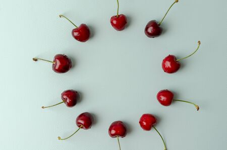 Cherry pattern. Flat lay of cherries and leaves on a olive background.Top viewの写真素材