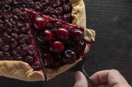 Tasty cherry pie on dark table withの写真素材