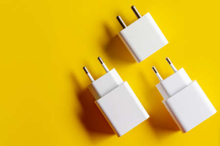 Different electric plug connector on yellow backgroundの写真素材