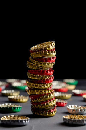 Large pile of beer bottle caps on black dark backgroundの写真素材