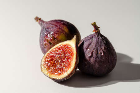 sliced fresh figs on white background with water dropsの写真素材