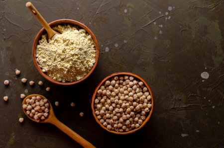 Chick Pea Flour with uncooked chickpea on darkの写真素材