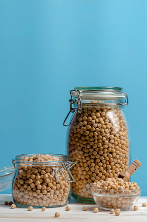 Jar with beans and legumes on blue background with