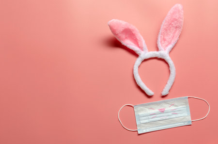 Easter bunny with medical mask on ink background. Easter conceptの写真素材