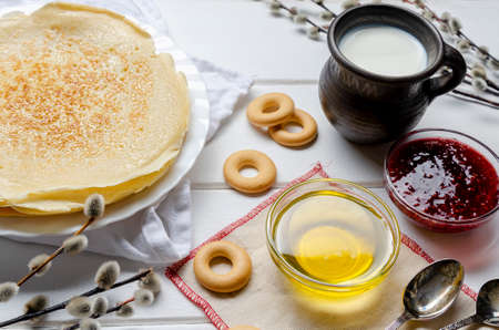 Shrovetide festival. Russian pancakes with willow branch on white wooden