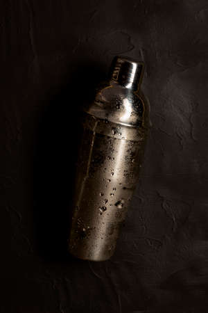Cocktail shaker on black background wirh water dropsの写真素材