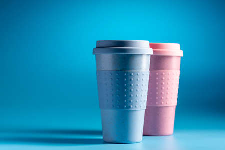 Reusable coffee cup on light blue background. Bamboo cup.の写真素材
