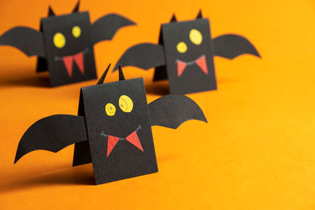 Halloween bat on orange background for Halloween.