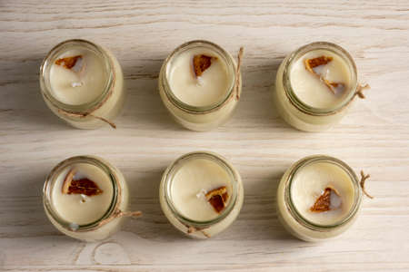 Set for crafting candle on wooden background. Eco soy wax on white table. DIY candle. Hobby concept.