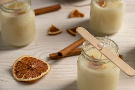 Set for crafting candle on wooden background. Eco soy wax on white table. DIY candle. Hobby concept.の写真素材