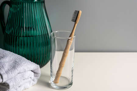 Eco friendly bamboo tooth brush on gray background. Space for textの写真素材