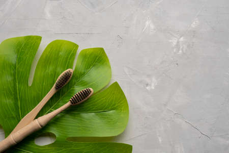 Eco friendly bamboo tooth brush on gray background. Space for textの写真素材