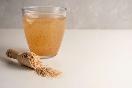 Psyllium in a glass on a white background with psyllium husk.の写真素材