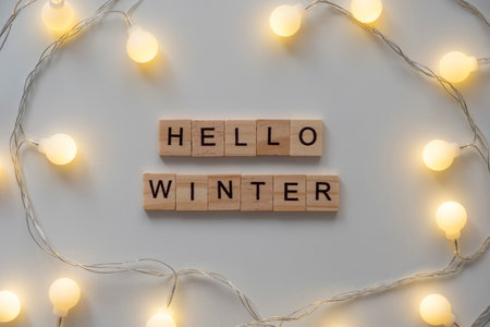 Winter card Hello, winter with garland white background. Top view.の写真素材