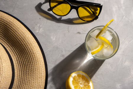 Lemonade with ice with hat and sunglasses. Summer holidays vacation concept backgroundの写真素材