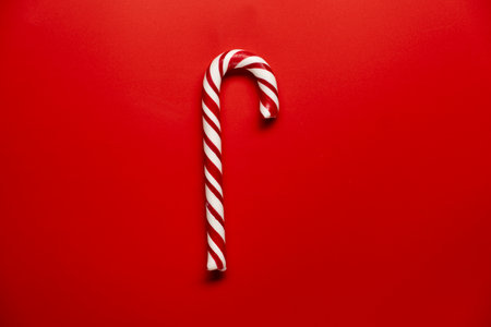 Christmas candy canes against a red background