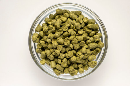 Pile of green hops pellets on white background.