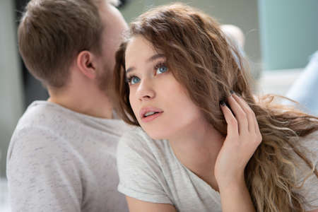 The girl looks up in surprise while the man looks away during the argument