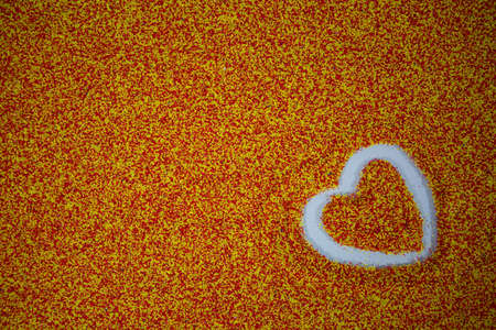 close-up photo of a heart Drawing on multicolored sandの写真素材
