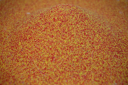 slide of red and yellow artistic sand, photo with selective focus
