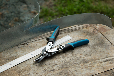 Tool tinsmith. Scissors on metal and a metal ruler.の写真素材