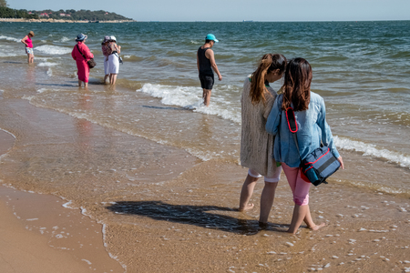 People on the bank of the Yellow Sea in Chinaのeditorial素材