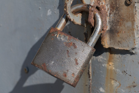 Rusty padlock on a metal doorの写真素材