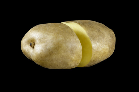 Potatoes from two halves on a black backgroundの写真素材