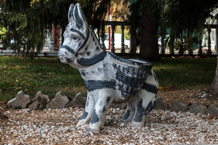 Sculptures of a little burro with baskets in parkの写真素材