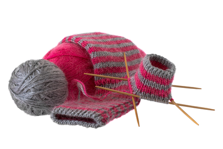 Knitted woolen sock and hanks of wool on a white backgroundの写真素材