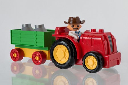 The children's tractor with milk goes to a farmの写真素材