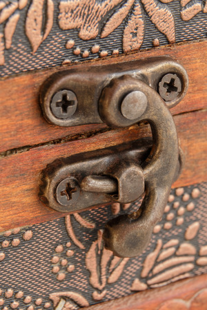 Metal latch on a wooden casket for jewelryの写真素材