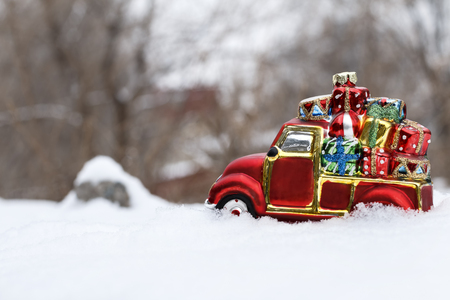 The toy car with gifts in deep snowの写真素材