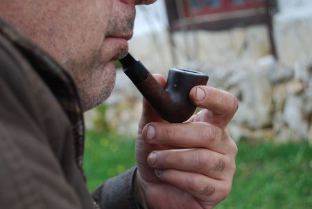 A man with a wooden pipe 