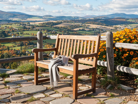 Wooden bench with blanket on the top of the mountain in autumnの素材