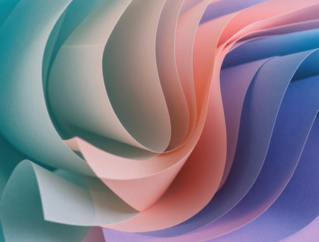 Layered paper sheets create soft, flowing abstract waves in pastel blues, pinks, and purples, forming a gentle gradient background with subtle texture and elegant movementの素材